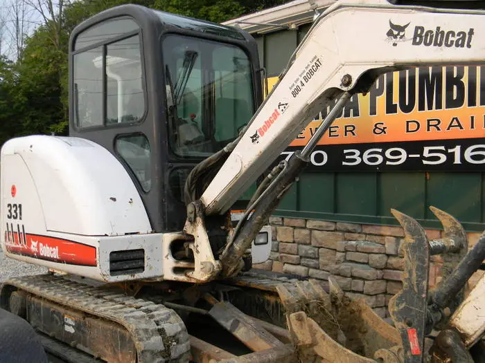 A Bobcat mini excavator parked outside the Amanda Plumbing shop on Columbus Pike in Delaware, Ohio